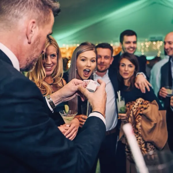 Guests reacting to Martin Sanderson’s magic at a private celebration