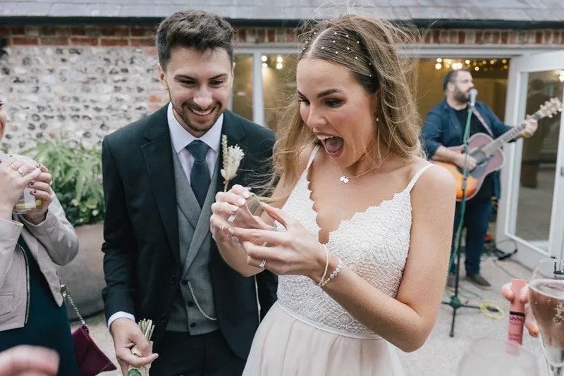 A bride and groom reacting to Martin Sanderson’s magic on their wedding day