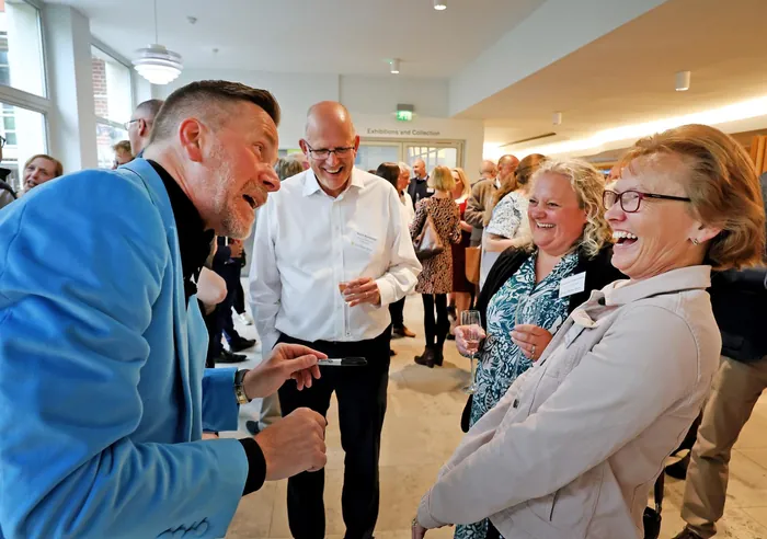 Martin Sanderson performing card magic during a drinks reception