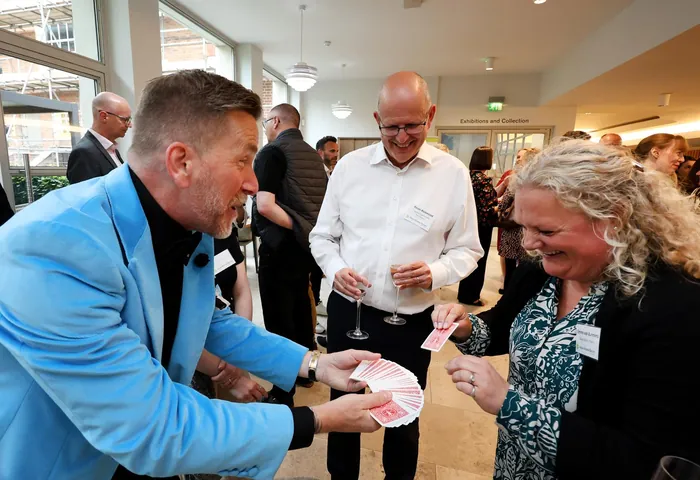 Delegates watching Martin Sanderson perform at a networking function