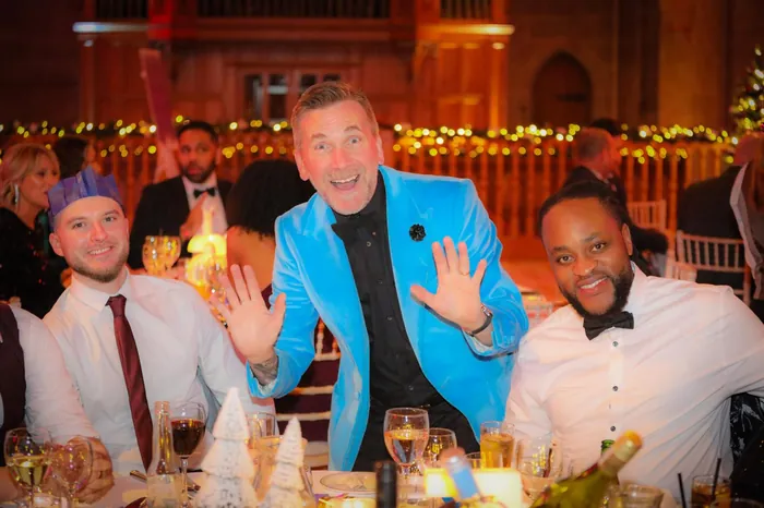 Martin Sanderson entertaining guests at a company Christmas party