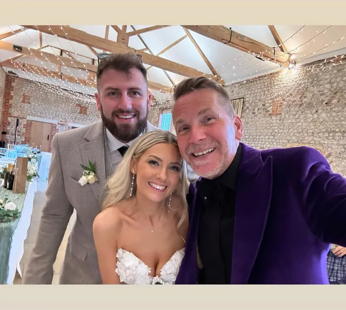 Martin Sanderson with a bride and groom during their evening reception