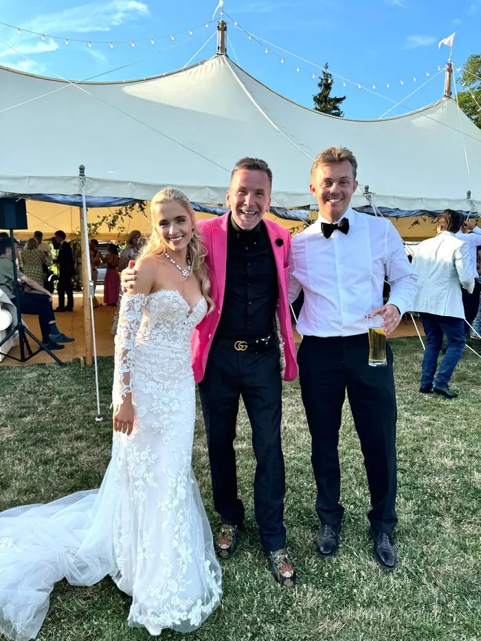 Martin Sanderson with a bride and groom outside their wedding venue