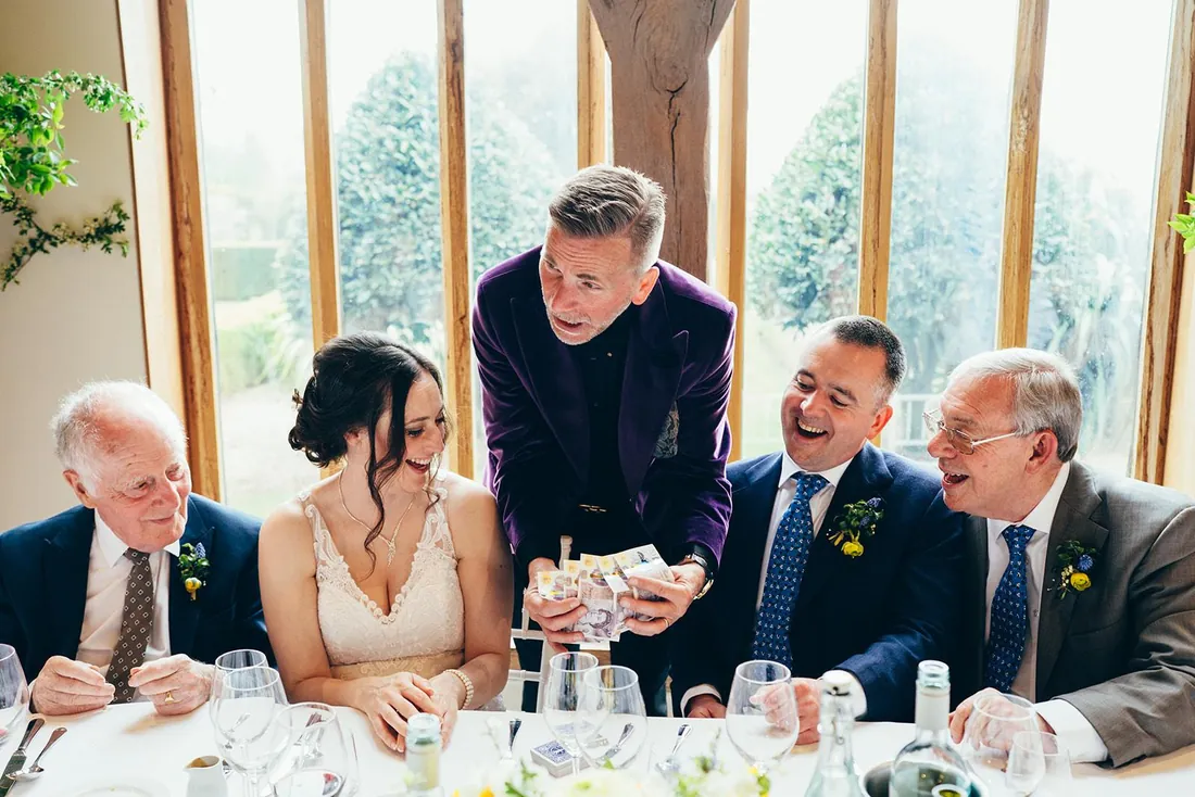 Martin Sanderson performing for the bride and seated guests during the wedding breakfast